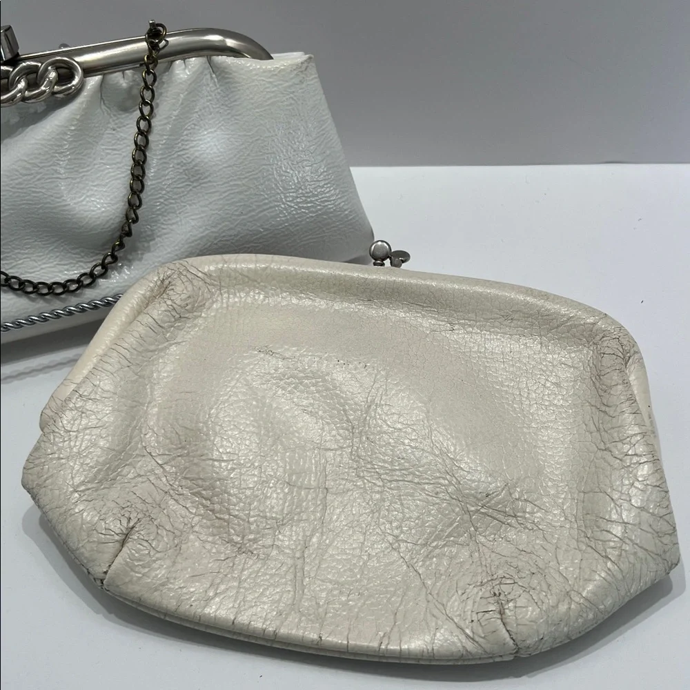 Vintage pair of white leather clutches, one is 70’s with great blk/white lining